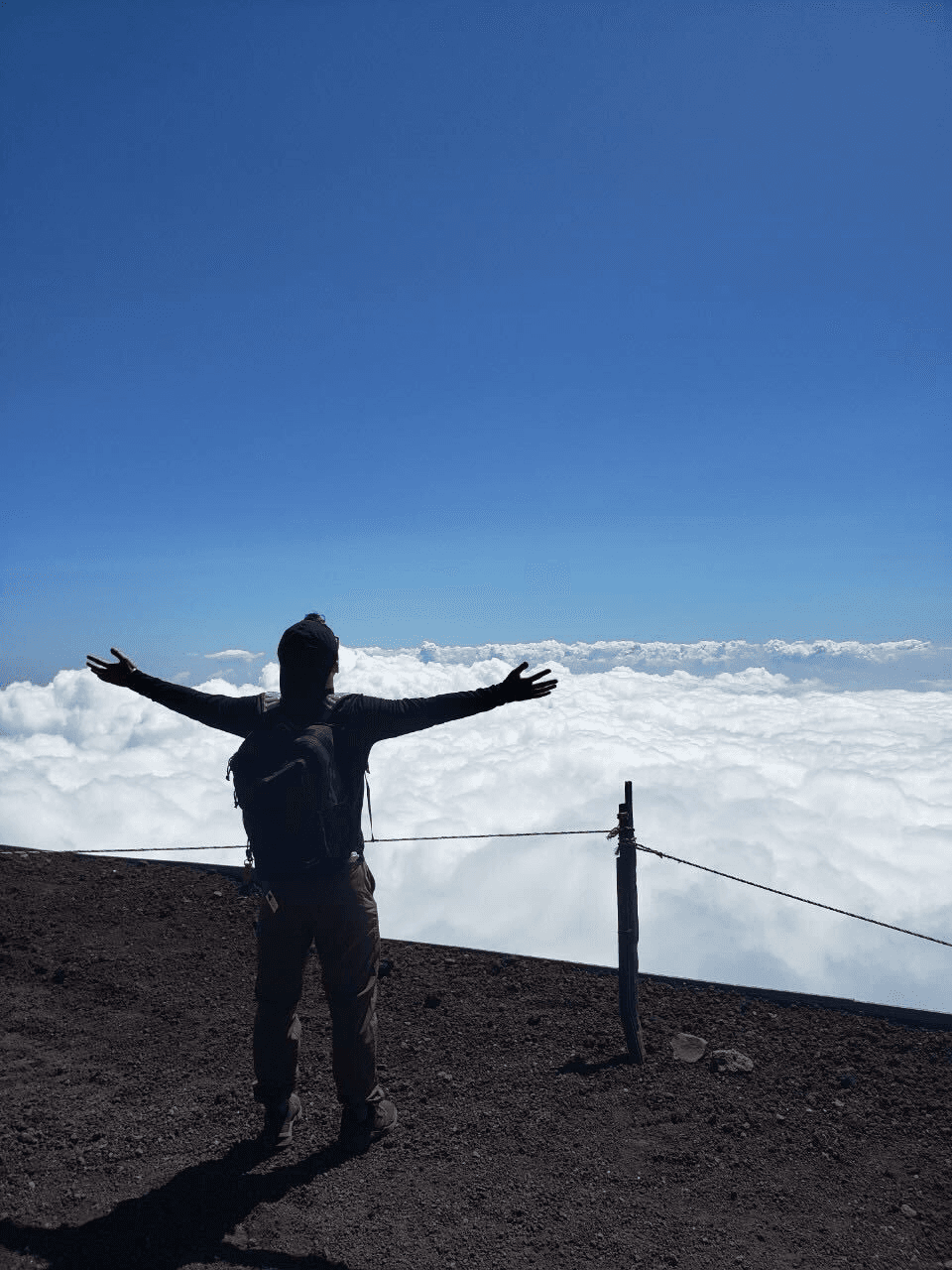 Me opening my arms wide open while climbing Mt. Fuji